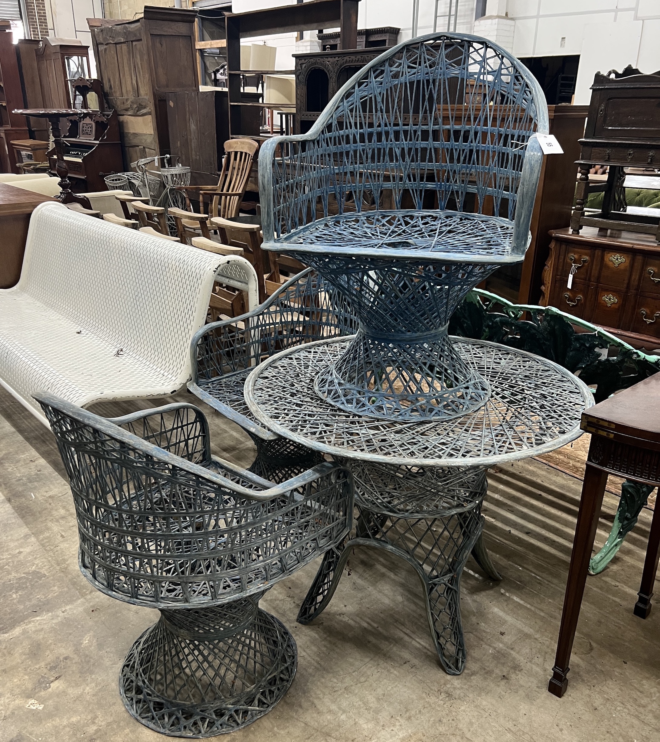 A Russell Woodard fibreglass garden table, diameter 89cm, height 70cm and three chairs